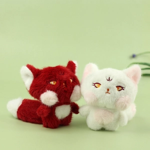 Close-up of plush fox pendants featuring detailed embroidery and soft faux fur texture