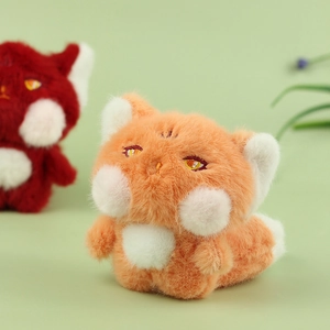 Close-up of cute plush fox keychains with soft orange fur and detailed embroidery