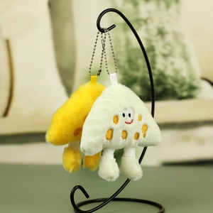 Detail of plush toast keychains with cute embroidery and metal chains on a stand