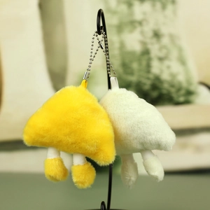 Close-up of cute plush mushroom charms with long faux fur and metal bead chains