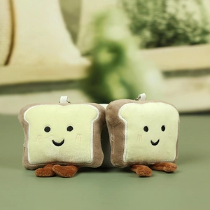 Close-up of plush toast bread charms with cute embroidered smiles and beaded metal chains