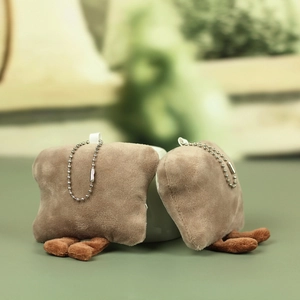Detail of cute plush toast bread pendants with tiny legs and silver metal bead chains