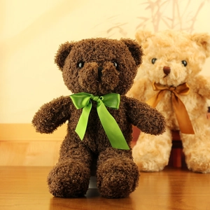 Detailed close-up of dark brown plush teddy bear featuring a vibrant green satin ribbon bow