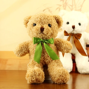 Close-up of brown and white seaweed teddy bears with satin silk scarf bowties