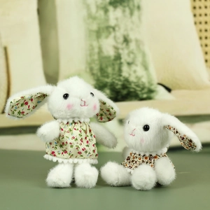Adorable white plush rabbit pair wearing floral dresses with soft texture details