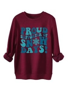 Detail of burgundy fleece sweatshirt featuring Snow Days print and soft interior texture