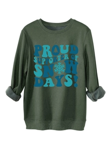 Detail of dark green sweatshirt showing soft grey fleece lining and festive winter print