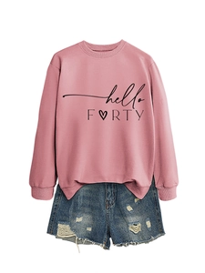 Detailed flat lay of pink hello FORTY heart sweatshirt paired with distressed denim shorts