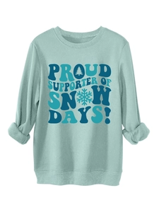 Detail of teal crewneck sweatshirt featuring winter-themed Snow Days print and ribbed cuffs