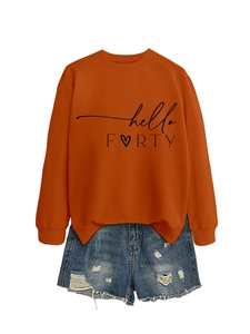Detail of hello FORTY orange sweatshirt with heart print and distressed denim shorts