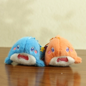 Close-up of cute plush shark keychains in blue and orange with detailed embroidery