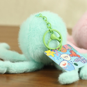 Macro shot of mint green plush keychain with plastic ring and Sea World themed tag