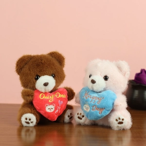 Detail of plush teddy bear charms featuring Only One and Happy Day heart embroidery