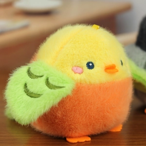 Macro shot of a colorful plush bird charm with vibrant embroidery on a wooden table