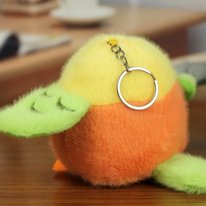 Close-up of colorful plush bird keychain with soft texture on a wooden table