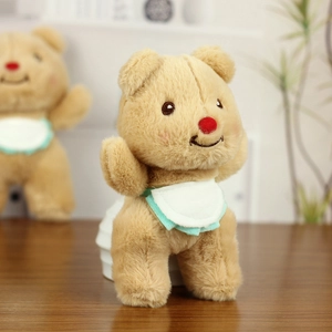 Close-up of cute plush bear with a brown soft texture and ruffled bib detail