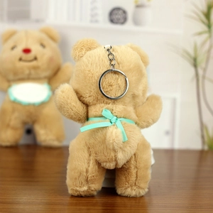 Detail of khaki plush bear keychain with mint green ribbon bow and silver metal clasp