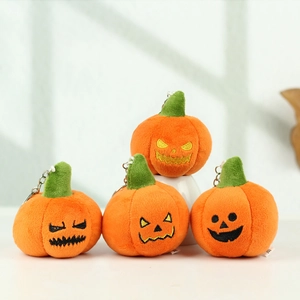 Set of four plush orange Halloween pumpkin keychains with funny facial expressions
