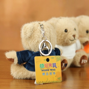 Cute teddy bear plush keychain wearing a blue sweater with silver metal clasp and tag