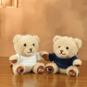 Detail of cute teddy bear plush charms with embroidered feet and colorful T-shirts