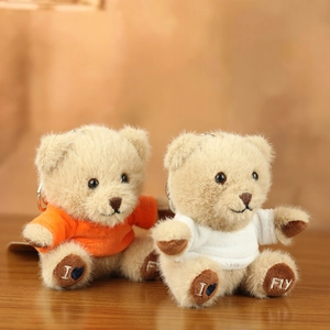 Close-up of soft plush teddy bear charms featuring embroidered paws and metal keychains