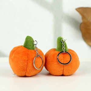 Detail of plush orange Halloween pumpkins with green stems and silver metal keychains