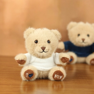 Close-up of teddy bear plush keychain with I love FLY embroidery on soft paws