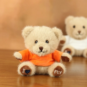 Close-up of plush teddy bear feet featuring I heart FLY embroidery on soft fabric