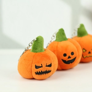 Close-up of Halloween pumpkin plush keychain with soft texture and metal clasp