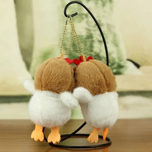 Detail of plush chicken charms with soft faux fur textures and gold metal chains