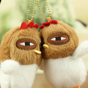 Close-up of cute plush chick pendants with soft texture and golden metal ball chains