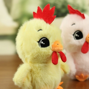 Close-up of soft plush chicken pendant with embroidery eyes and fluffy texture details