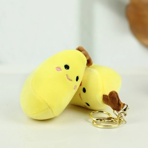 Simpatico portachiavi in peluche a forma di durian con viso sorridente e gancio d'oro
