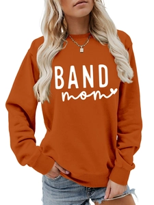 Detail of burnt orange sweatshirt with white BAND mom text and small heart print