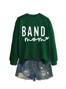 Close-up of dark green BAND mom sweatshirt with heart print and distressed denim shorts