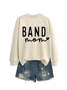Flat lay of cream crewneck sweatshirt with black BAND mom print and denim shorts