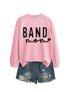 Flat lay of pink Band Mom sweatshirt paired with distressed blue denim shorts