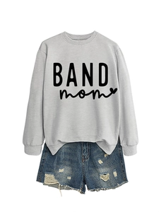 Detail of BAND mom print on a grey long sleeve sweatshirt and distressed denim shorts