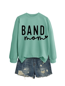 Sage green long sleeve sweatshirt with BAND mom text and denim shorts outfit flat lay