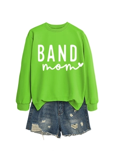 Flat lay of a green long-sleeve sweatshirt with BAND mom print and blue denim shorts