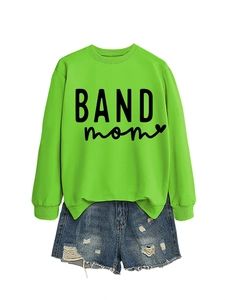 Detail of neon green crewneck sweatshirt with black BAND mom print and distressed denim shorts