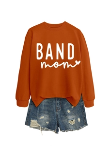 Flat lay of rust red sweatshirt with BAND mom text and distressed blue denim shorts