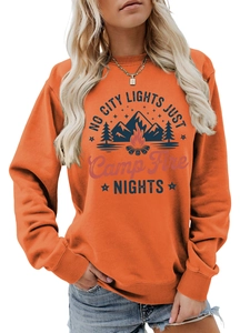 Detail of orange crewneck sweatshirt featuring outdoor camping graphic and ribbed cuffs