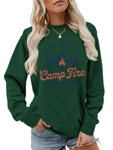 Detail of dark green sweatshirt featuring camping fire and mountain graphic print