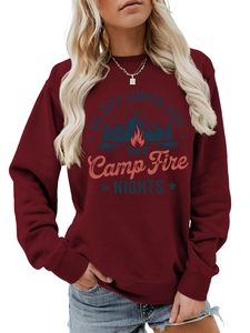Close-up of wine red sweatshirt featuring nature campfire graphic and rib-knit cuffs