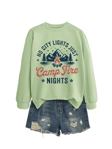 Detail of the campfire graphic print and text on a sage green fleece crewneck sweatshirt