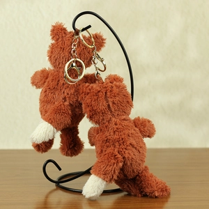 Pair of cute plush peanut fox keychains in soft caramel brown fur with golden metal clasps