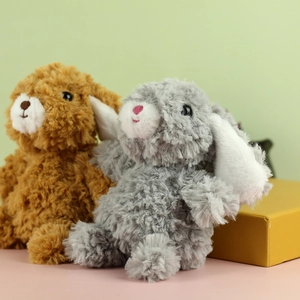 Dettaglio di morbidi peluche di coniglietto con orecchie lunghe marroni e grigi