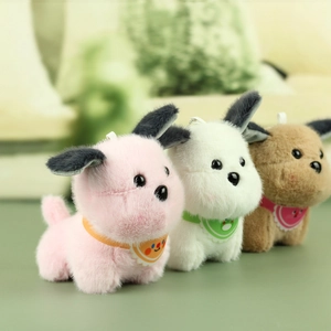 Three plush puppy keychains in pink, white, and brown with colorful cartoon scarves