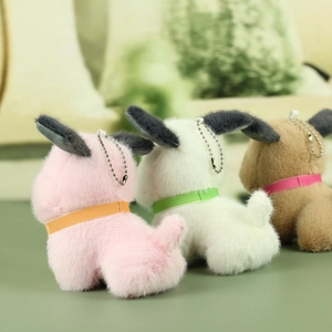 Plush dog keychains in pink, white, and brown with long ears and colorful ribbon collars